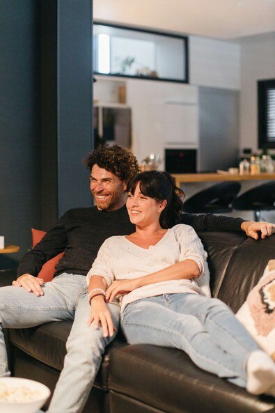 couple watching movie on a sofa