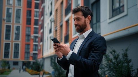 business man using his smartphone in the street