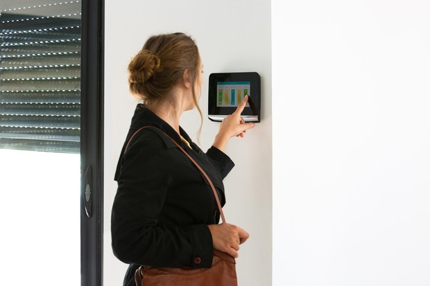 woman activating video door phone indoor monitor